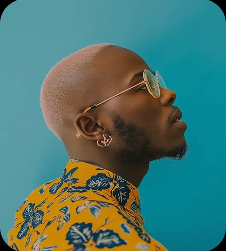 Man with glasses in yellow patterned shirt